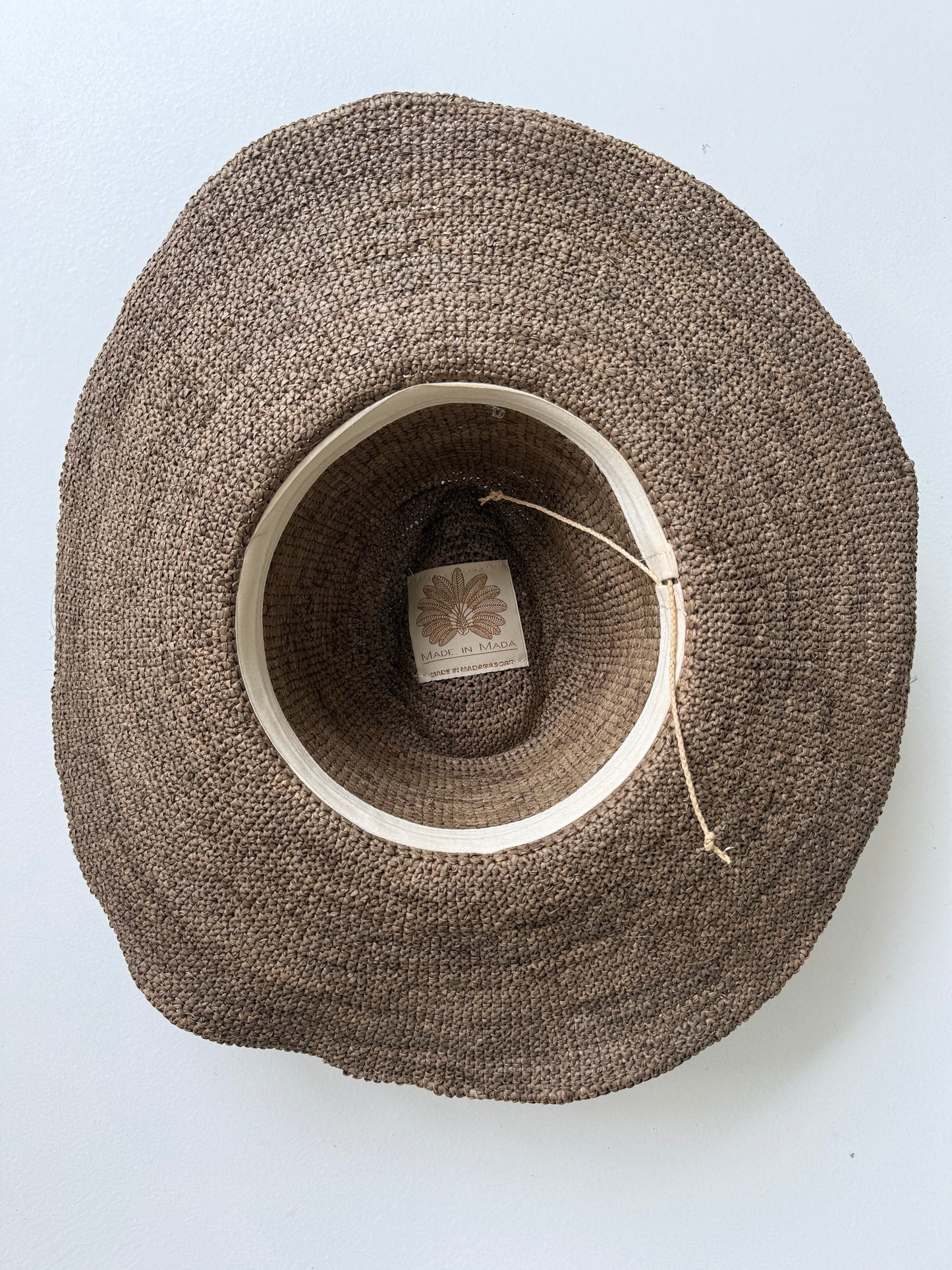 Inside view of the Aziz Tan Leather Hat tea with cotton inner band and adjustable cord